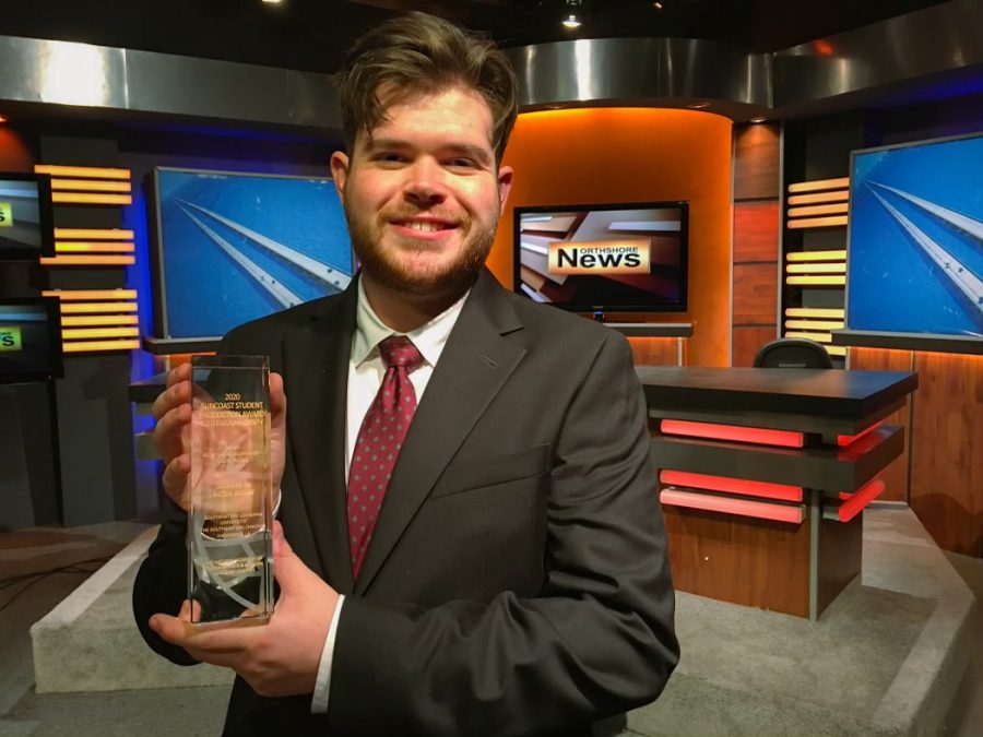 Senior communication major John Williams holds his 2020 Suncoast Region Emmy award he received for his feature story production “July Fourth in Baton Rouge.
