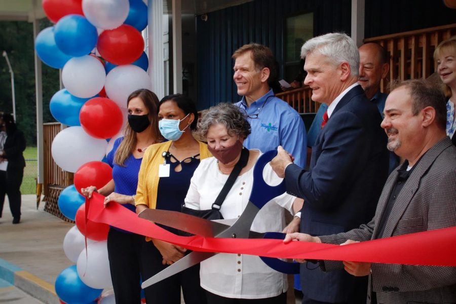 U.S. Sen. Bill Cassidy cuts the ceremonial ribbon alongside administrators of the Regina Coeli Child Development Center and other contributors of the new building. 