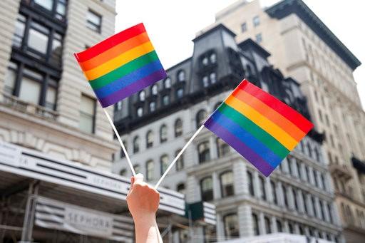 An attendee holds up flags during the New York City Pride Parade, Sunday, June 24, 2018, in New York. (AP Photo/Steve Luciano)