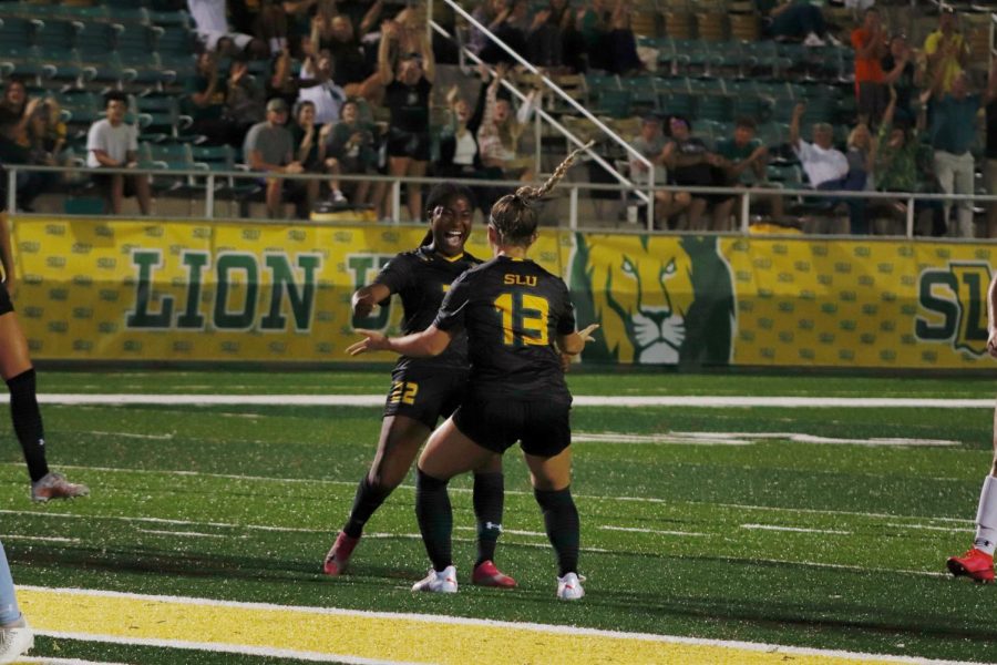 Maycie Massingill celebrates with Shamoy Campbell after scoring the first goal of her collegiate career. 
