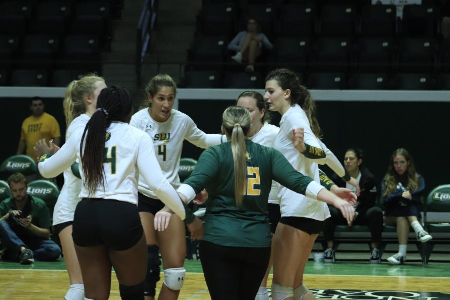 The Lady Lions huddle up during the Oct. 21 match against Nicholls State University.