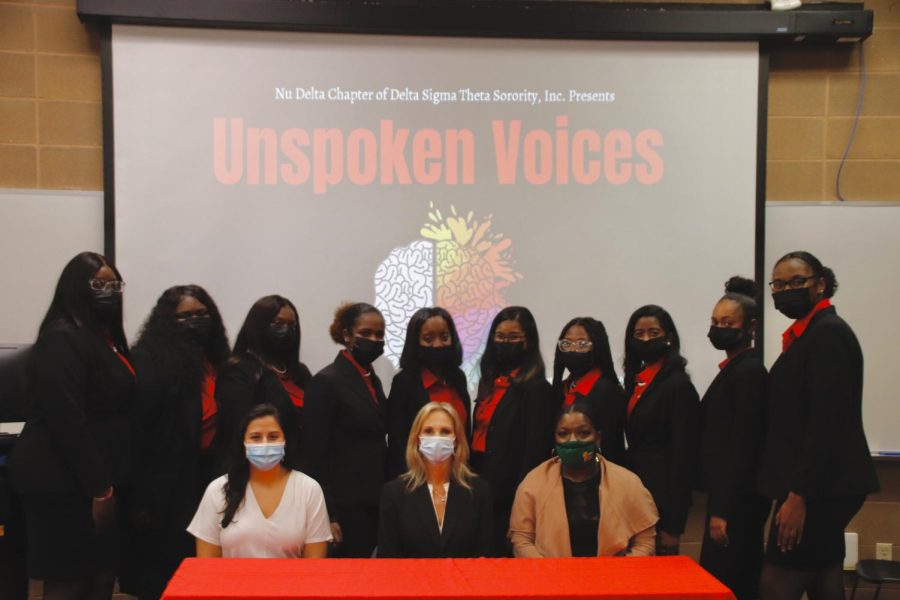 The Nu Delta Chapter of Delta Sigma Theta Sorority stands with the three speakers of the Unspoken Voices seminar. In the front row, the speakers from left to right are Marcela Spicuzza, Paige Moody and Jessica McMillian.