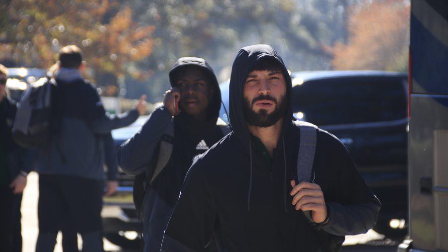 Wide receiver Justin Wendt heads to the buses during the Football Sendoff Friday morning, Dec. 4. 