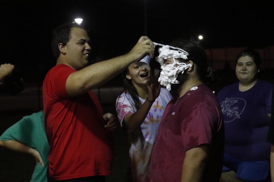 CSA Vice President Chris Arroyo sprays shaving cream on Senior History Major and CSA Member Michael DeGraauw as part of their annual Messy Games meeting. CSA hosts meetings every Wednesday at 7:00 p.m. at the St. Albert Catholic Student Center. 