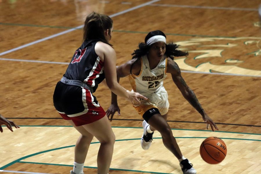 Senior guard Breonca Ducksworth dribbles the ball past William Carey University's defense at the Dec. 11 home game. The Lady Lions defeated the Crusaders 68-28.