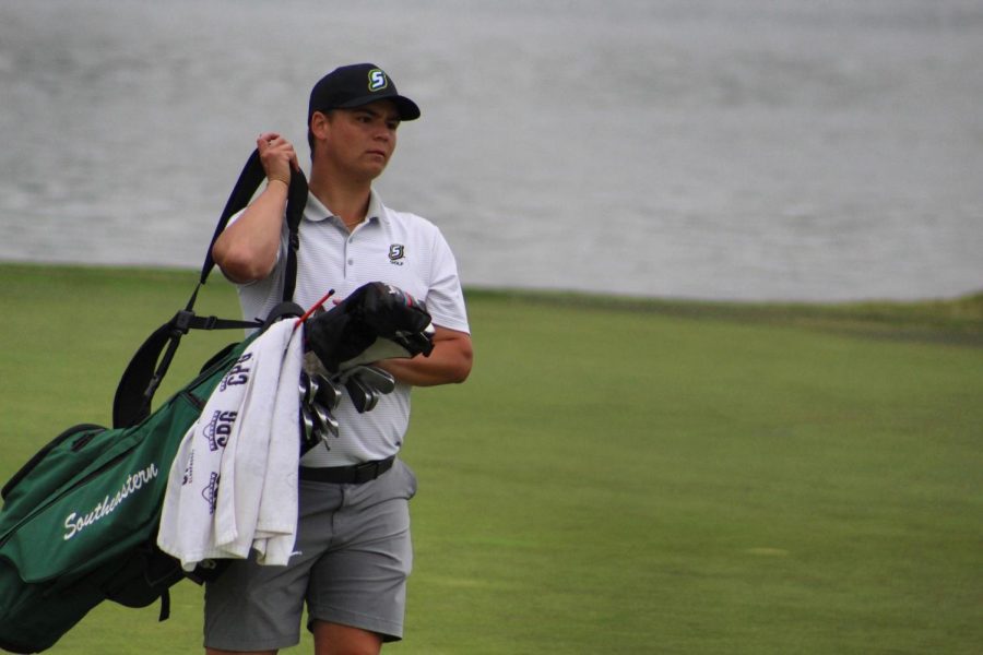 Southeastern golfer Zack Barrios carries his bag of clubs up to the eighteenth hole during Southland Conference tourney this past Spring.