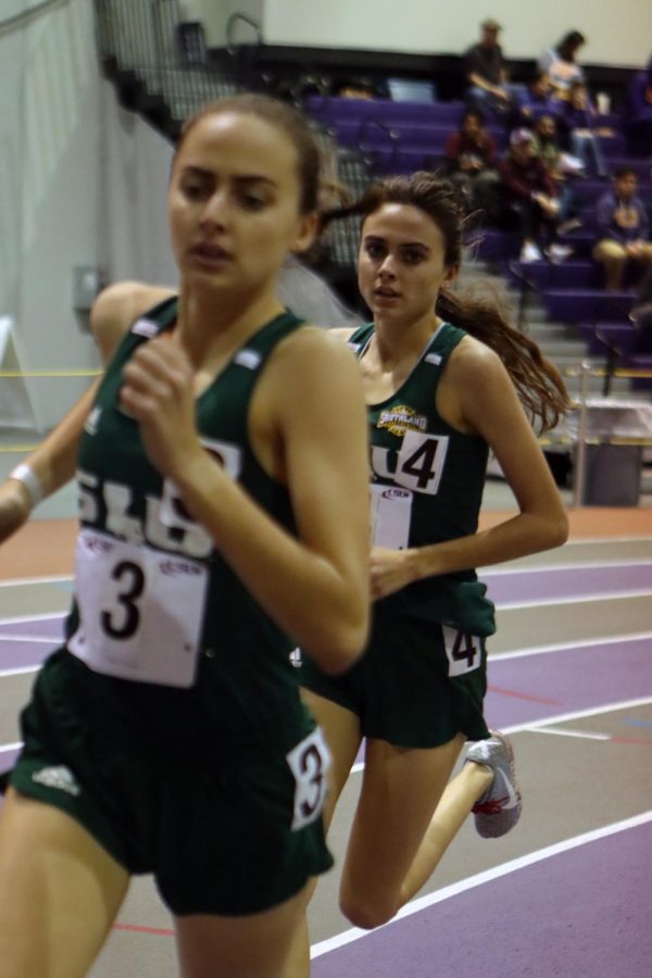 Juniors Brigid and Bernadette Tournoux round the curve of the 800-meter race. The twins compete to improve their ranking going into Conference.