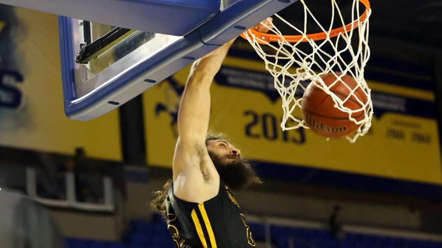 Junior guard Joe Kasperzyk makes a dunk during the Feb. 3 basketball game against McNeese in Lake Charles.