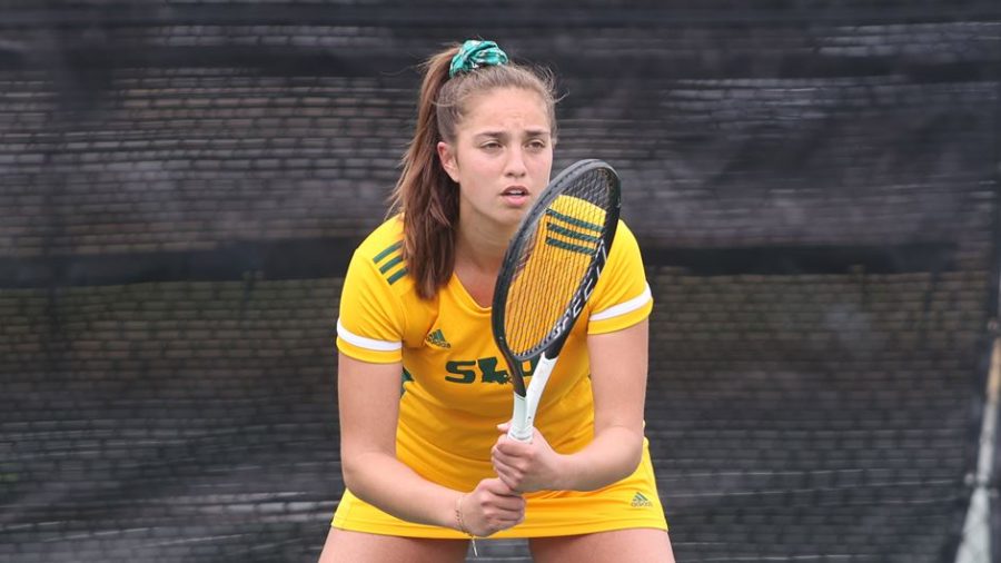 Junior Flory Bierma concentrates on the court during the Feb. 5 tennis match against the University of Wyoming.