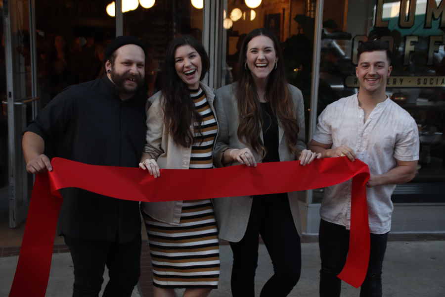 Owners of Luma Coffee Roasters proudly show off their ribbon. Luma was one of two other businesses who celebrated their openings with a ribbon cutting. 