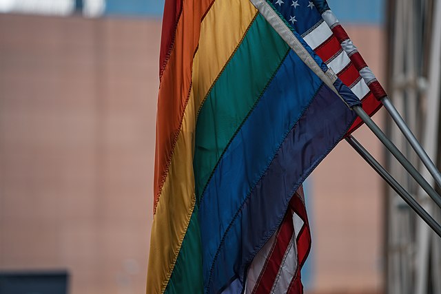 640px-Rainbow_Flag_and_American_Flag_-_Gay_Pride_(28219386627)