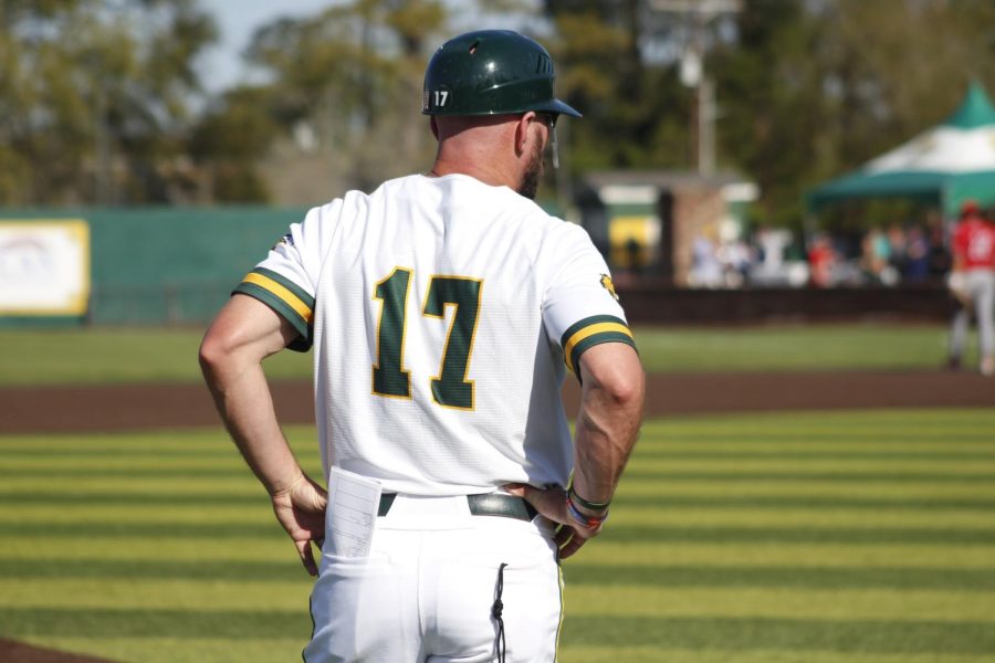 Head coach Matt Riser is preparing to call players as a third-base coach. 