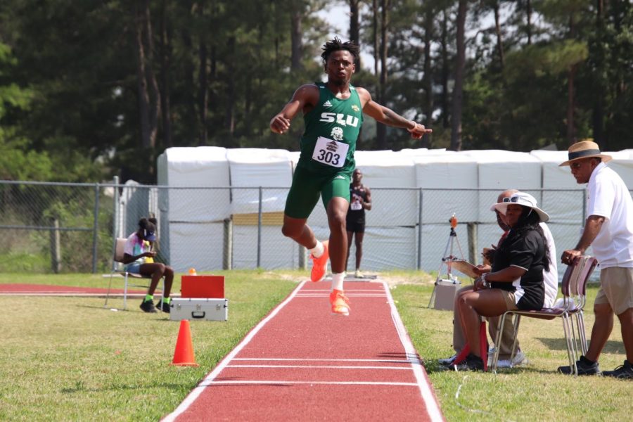 Wjuantereuas Rodrigue leaps through the air to set Southeastern record in long jump.