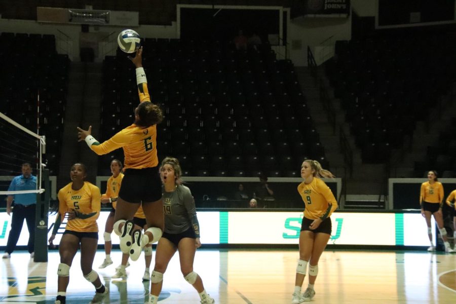 Junior Kailin Newsome makes a jump for the ball during the scrimmage on Aug. 18. The volleyball season will begin with the Katrinka Crawford Invitational.
