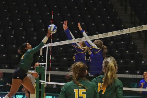 Junior Outside Hitter Kailin Newsome meets opposition at the net in an attempt to score her side a point at the University Center. (9/27/2022)