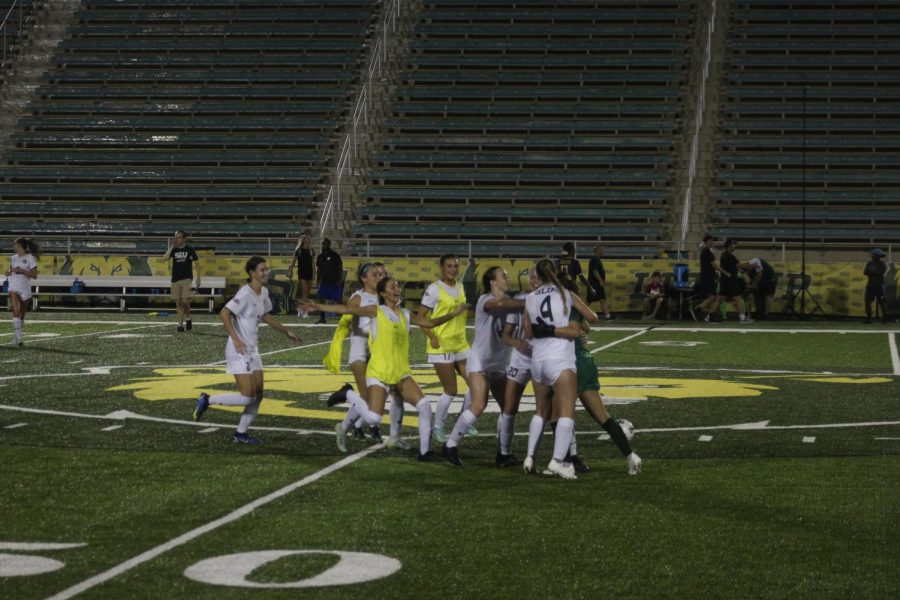 Teammates run towards the center of the field for a celebratory hug. The Lady Lions took the win over Southern 3-2 with the winning goal scored by center-back Emma Jones.