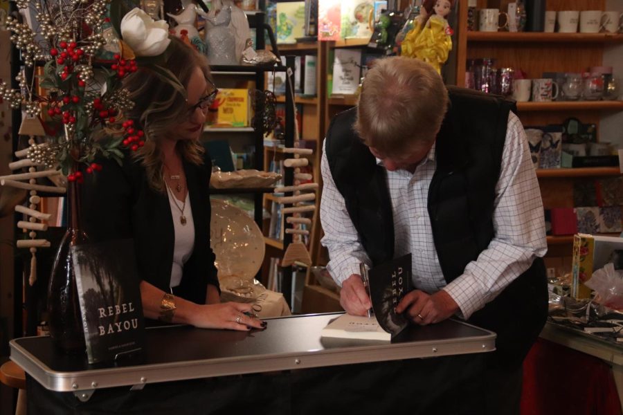 Dr. Samuel Hyde signing a copy of "Rebel Bayou." This book is now available at Bayou Booksellers in downtown Hammond. 