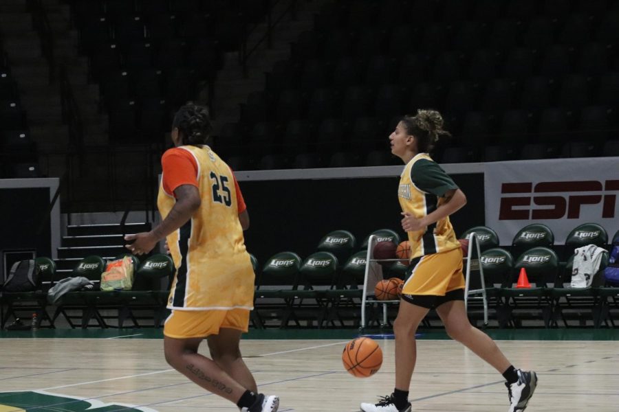 Sophomore guard Taylor Bell (left) accompanies senior point guard Cierra Carpenter (right) up the court at the University Center during practice in preparation for the season.