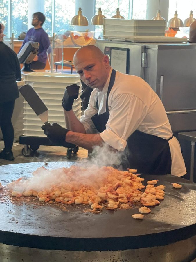 Chef Trey cooks shrimp for the Shrimp and Grits pop up at the Mane Dish. Chef looks forward to improving and bringing new food options to the Mane Dish for students to enjoy.