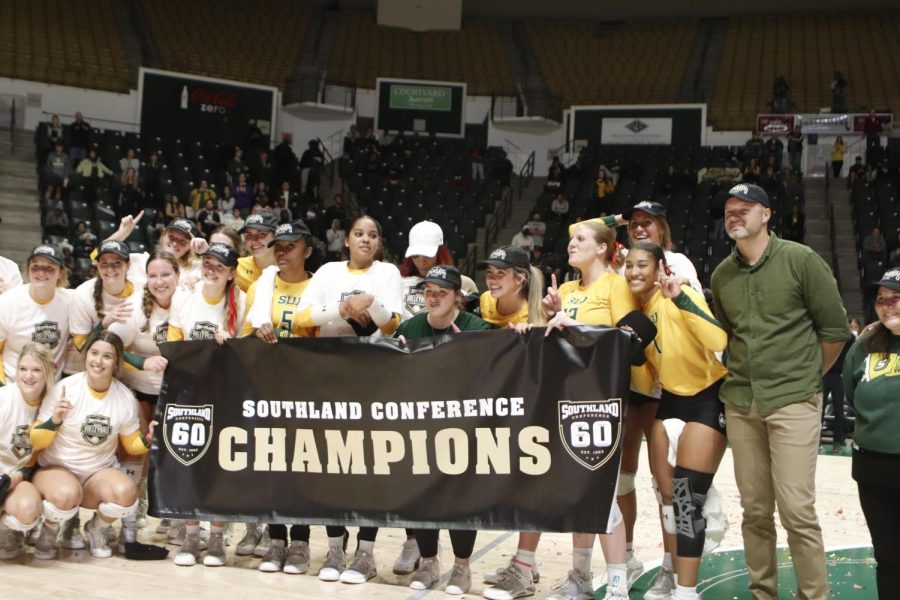 Head Volleyball Coach Jeremy White (pictured on the far right) with his team at the University Center moments after capturing the first Southland Conference title in school history. (Nov. 20, 2022)
