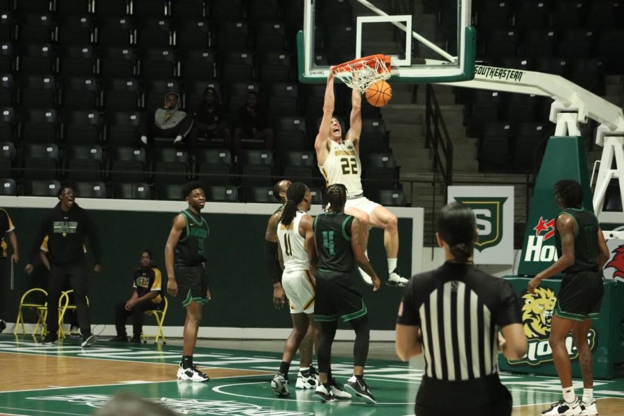 Junior forward Nick Caldwell rocks the rim at the University Center during Southeasterns 107-71 victory over Belhaven back in December. (Dec. 7, 2022)
