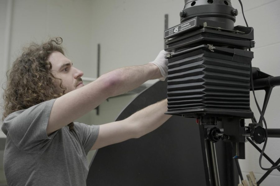 Corey Saltaformaggio uses Southeastern's dark room lab equipment to process his film for his senior art exhibition.