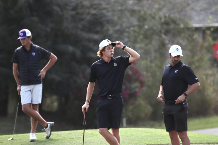 Sophomore Charlie Forster looking out on the green next to fellow player and Head Coach Lawrence Allan at the Gulf Coast Collegiate Tournament in Diamondhead, Miss. (Feb. 28, 2023)