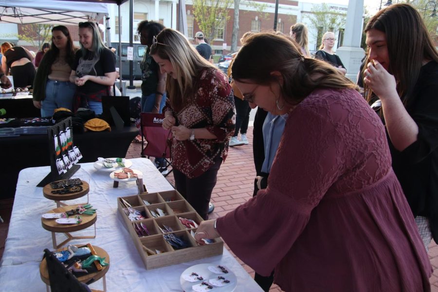 Patorns of the 106 Night Market checking out one of the vendors tables on March 16. 