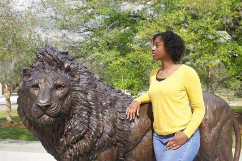 Hayley Anthony looks out onto the street as she stands next to the lion statue at Friendship Circle. 