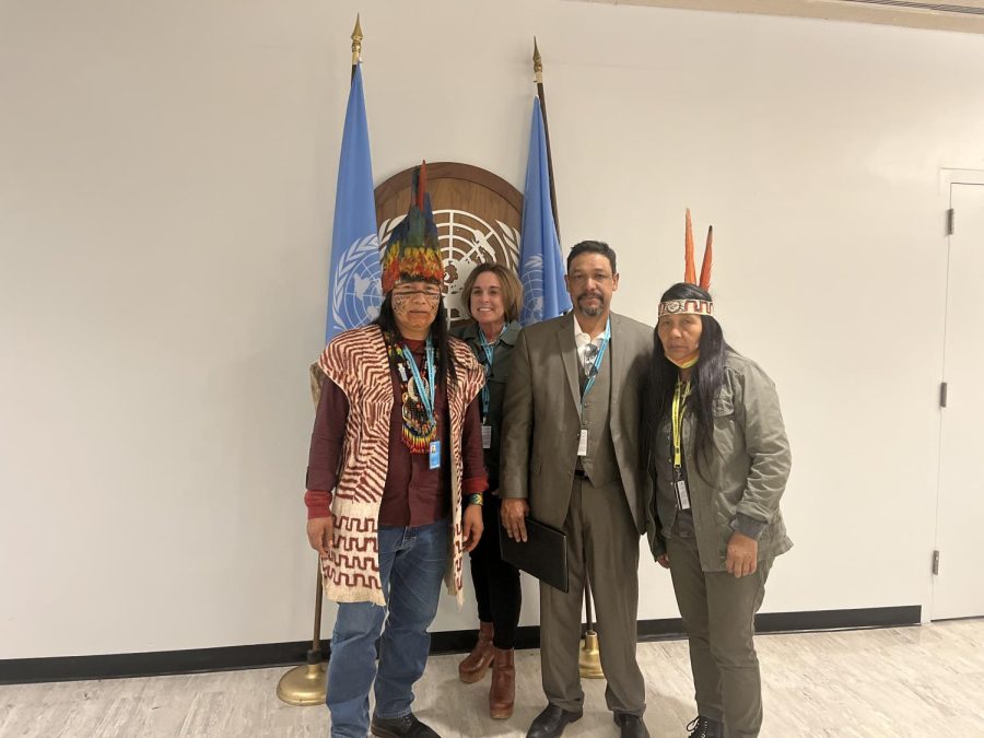 Dr. Laura Herlihy standing and smiling with Indigenous representatives during the United Nations Permanent Forum on Indigenous Issues this past April. 
