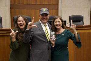 President-Elect Wainwright poses with the Southeastern classic Lion Up hand signal. With him is his daughter Ella Grace, his wife Misty, and their son Zachary, who couldnt be present for the day.
