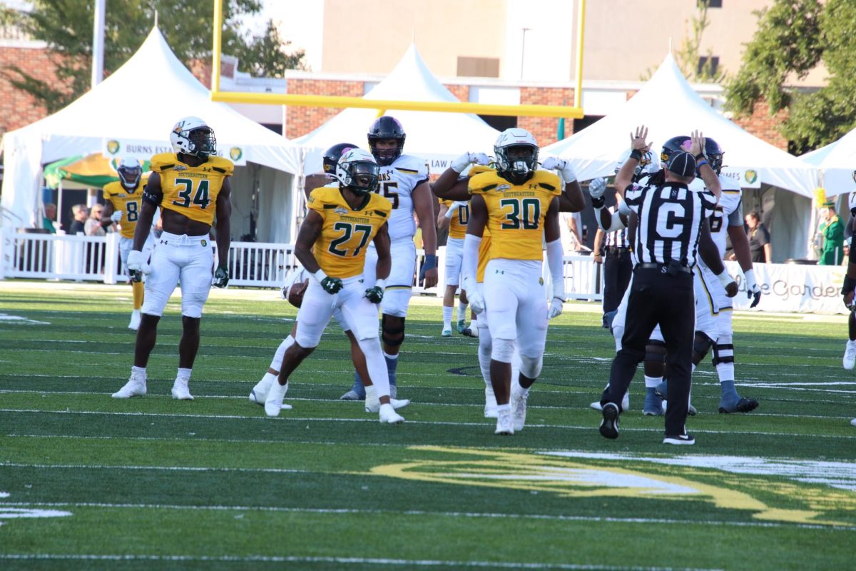 Arlan Williams (No. 34), Donte Daniels (No. 27) and Anthony Britton Jr. (30) celebrate a big defensive play against Texas A&M-Commerce during last years Homecoming game at Strawberry Stadium. (Oct. 8, 2022 - Hammond)