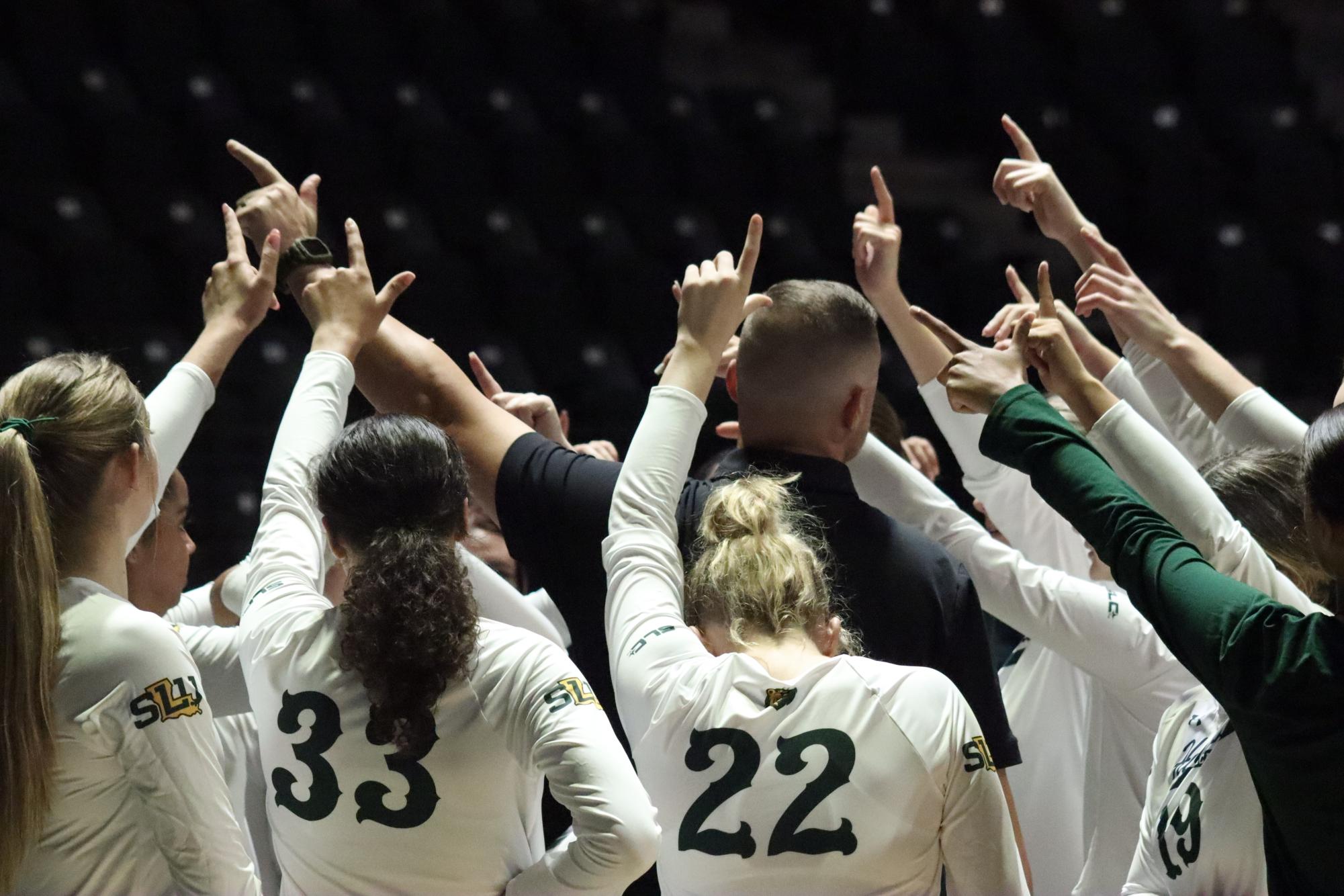 SLU players give the Lion Up sign in their team huddle during a game against Washington at the Pride Roofing University Center. (Aug. 25, 2023 - Hammond)