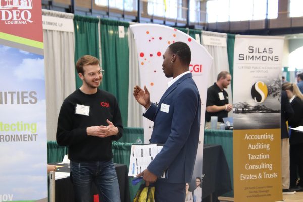 Senior marketing major Kyle Chatman discusses his interests to an employee from CGI at the 2022 Career Fair. 