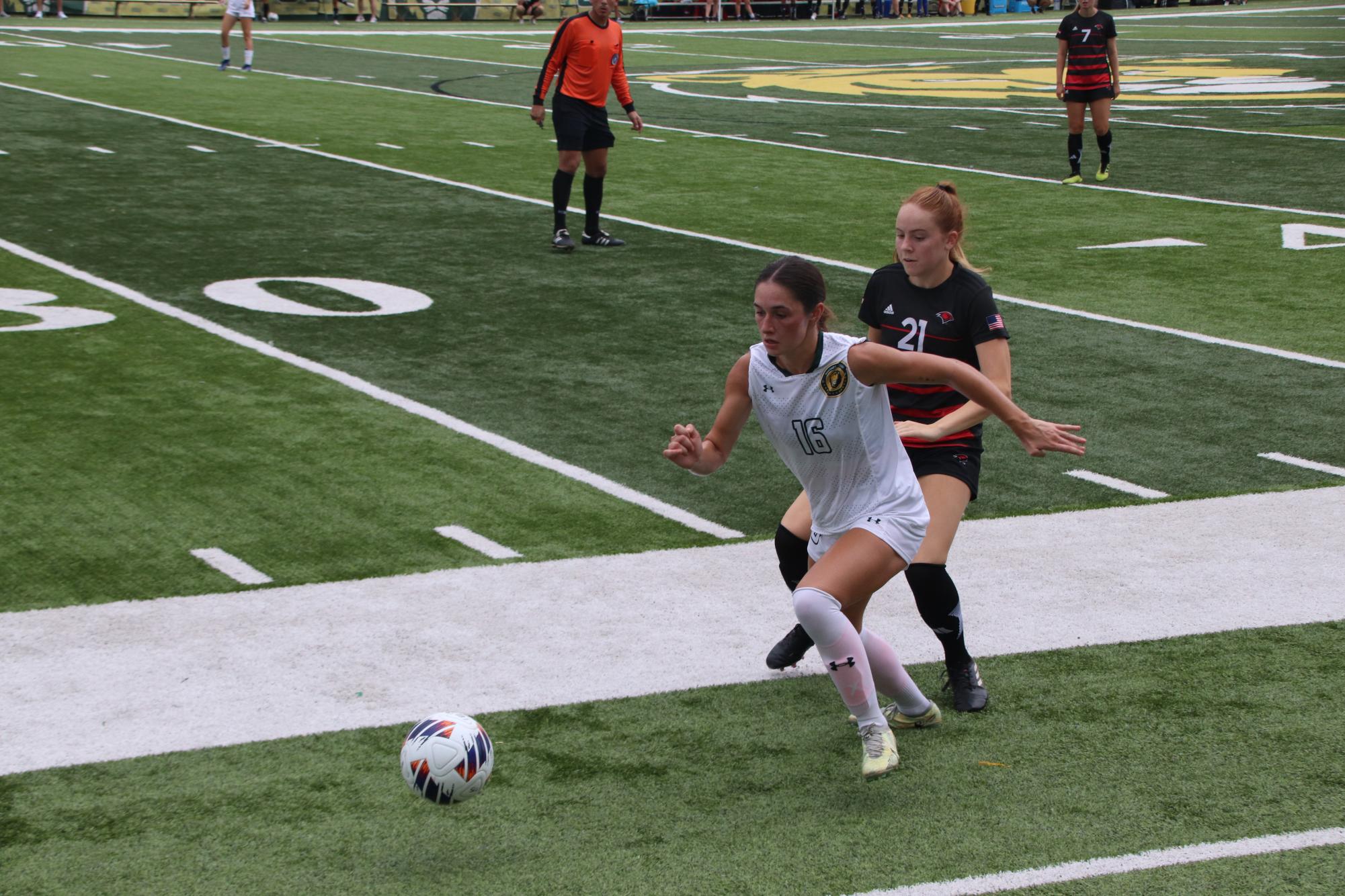 Senior SLU defender Nicole ONeill running to gain possession of the ball while shielding an opposing UIW player. (Sept. 24, 2023 - Hammond)