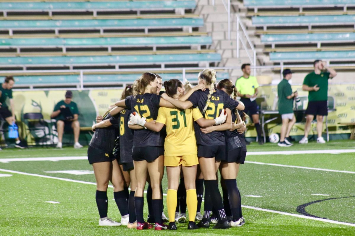 The Lady Lions huddle together before the game begins against Texas A&M-Commerce at Strawberry Stadium. (Sept. 29, 2023 - Hammond)