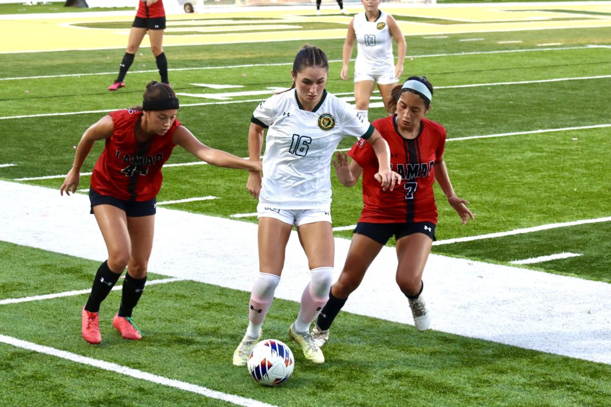 A pair of Lamar players swarm senior midfielder Nicole ONeill who maintains possession of the ball. (Oct. 1, 2023 - Hammond)