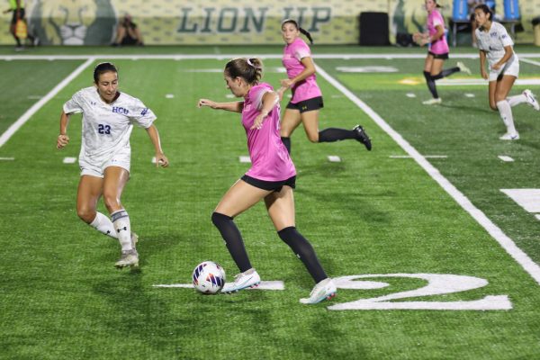 SLU sophomore midfielder Maggie Denison takes on defender during Pink Out victory over HCU, 2-1 at Strawberry Stadium. (Oct. 13, 2023 - Hammond)
