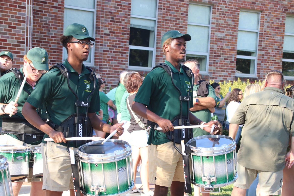 The+drumline+performs+alongside+the+Spirit+of+the+Southland+Marching+Band++outside+of+Pottle+Hall+during+a+tailgate+before+the+HCU+football+game.