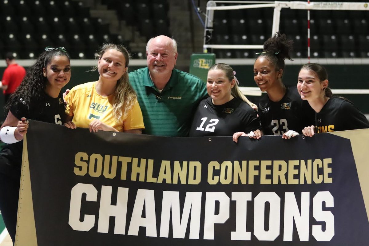 The+Lady+Lions+lift+the+2023+Southland+Conference+regular+season+championship+banner+following+their+win+over+Lamar.+