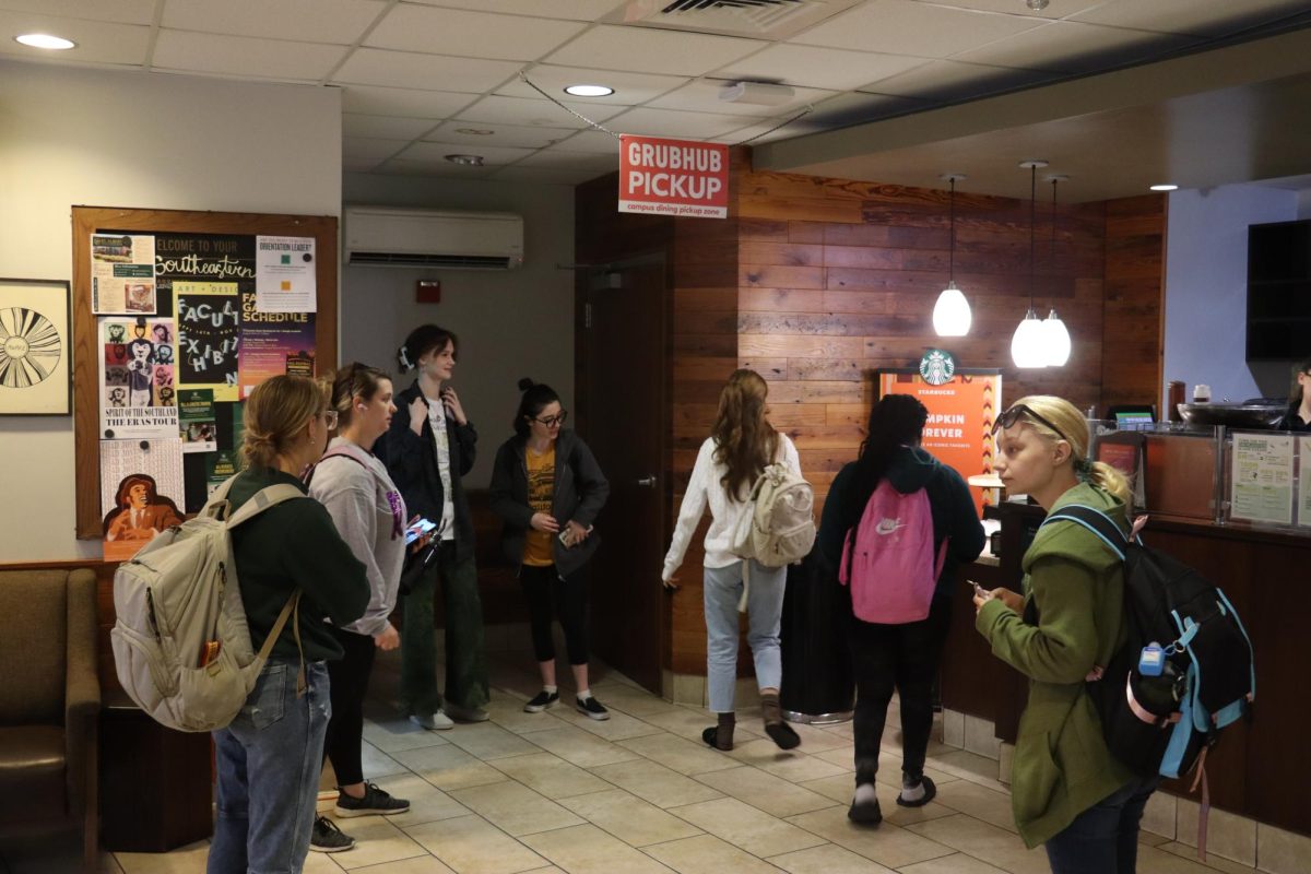 Students wait in the Starbucks lobby for their orders.