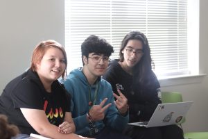 Freshmen English majors Aether Arcana, Philip Heiderick and Lilith Finnell discuss horror narratives during the Southeastern Lion Writers meeting.