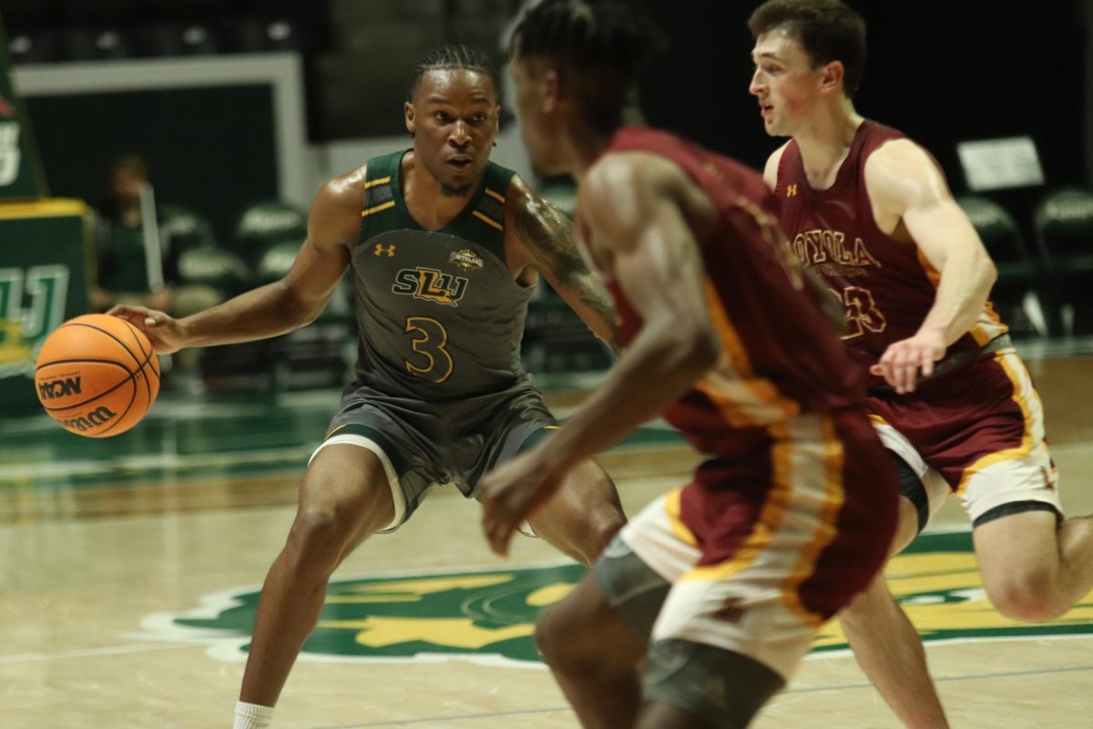 Junior SLU guard Roger McFarlane sizes up Loyola New Orleans defender during contest at the Pride Roofing University Center. McFarlane paces the Lions with 13.5 points per game. (Dec. 30, 2023 - Hammond)