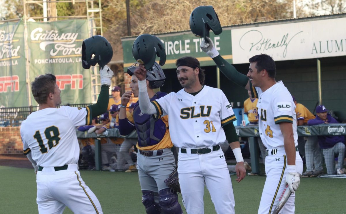 Lions players (pictured center - Gray Rowlett, pictured right - TJ Salvaggio) celebrate at home plate following Christian Garcias (pictured left) three run homer against LSUA. (Pat Kenelly Diamond at Alumni Field - Hammond)