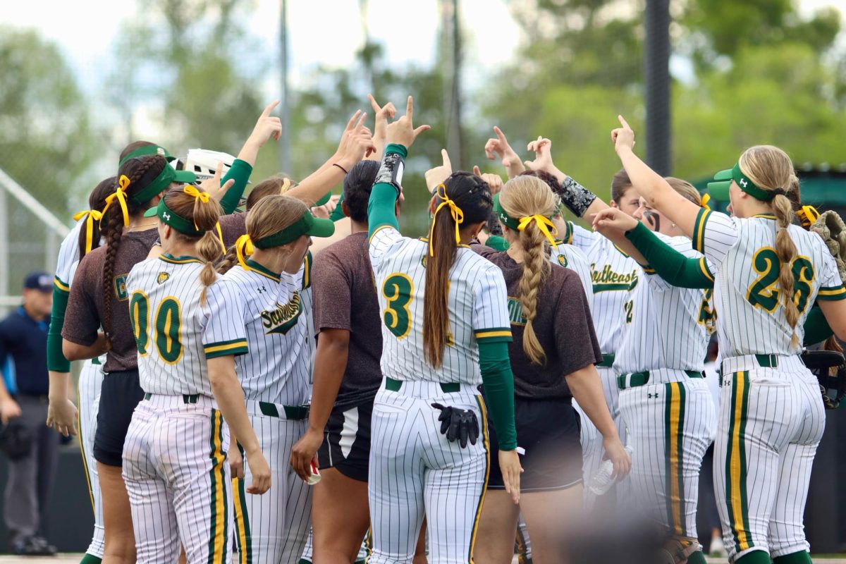 Softball+huddling+up+with+outreached+hands+as+they+celebrate+their+victory+against+HCU+on+Friday.+%28March+23%2C+2024-+Pat+Kenelly+Diamond+at+Alumni+Field+%E2%80%93+Hammond%29%0A