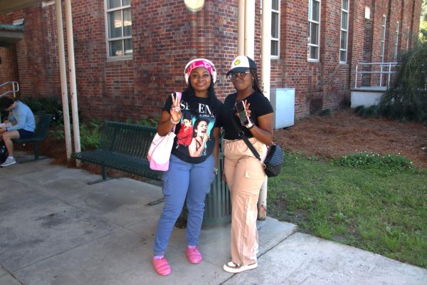 Students, Daja Newsome and Rayan Reese pose outside the Science Building Annex showcasing their personal styles.
