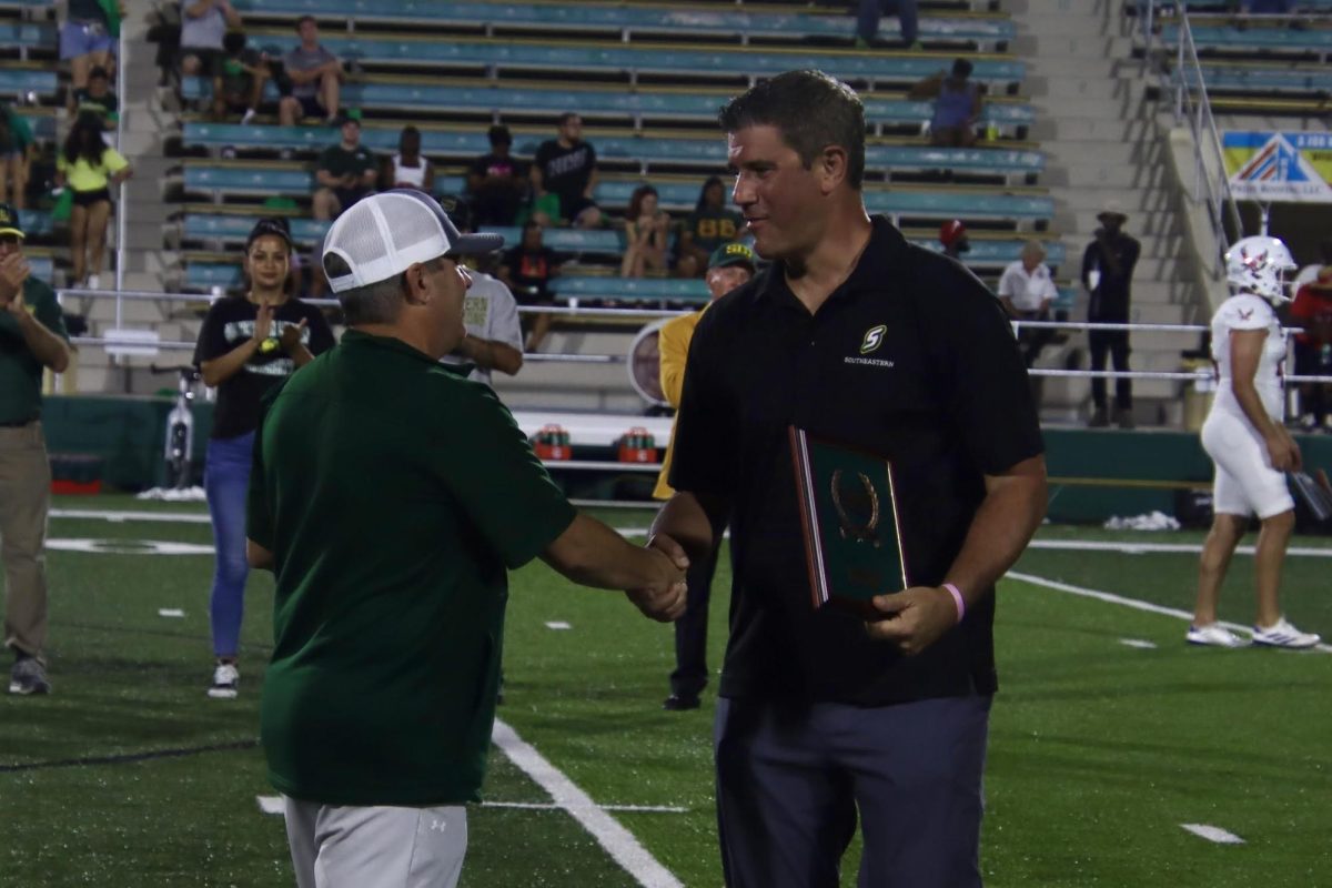 Chris Laiche receives his Hall of Fame plaque from Southeastern's Athletics Director Jay Artigues during halftime of SLU's 28-24 win over Eastern Washington. (Sept. 14, 2024 - Hammond)  