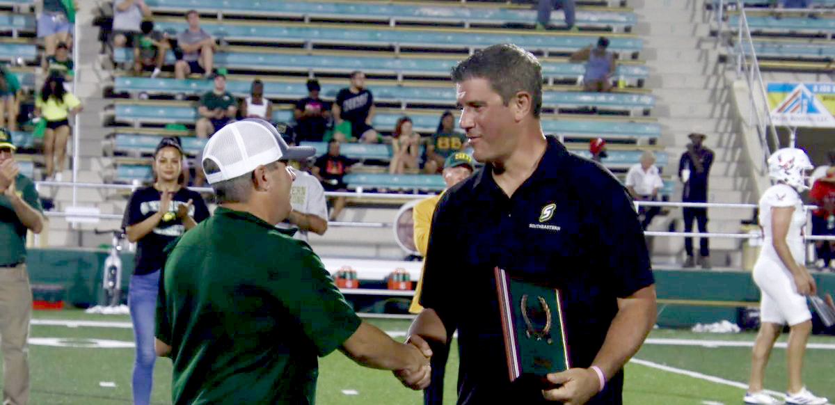 Chris Laiche receives his Hall of Fame plaque from Southeastern's Athletics Director Jay Artigues during halftime of SLU's 28-24 win over Eastern Washington. (Sept. 14, 2024 - Hammond)  