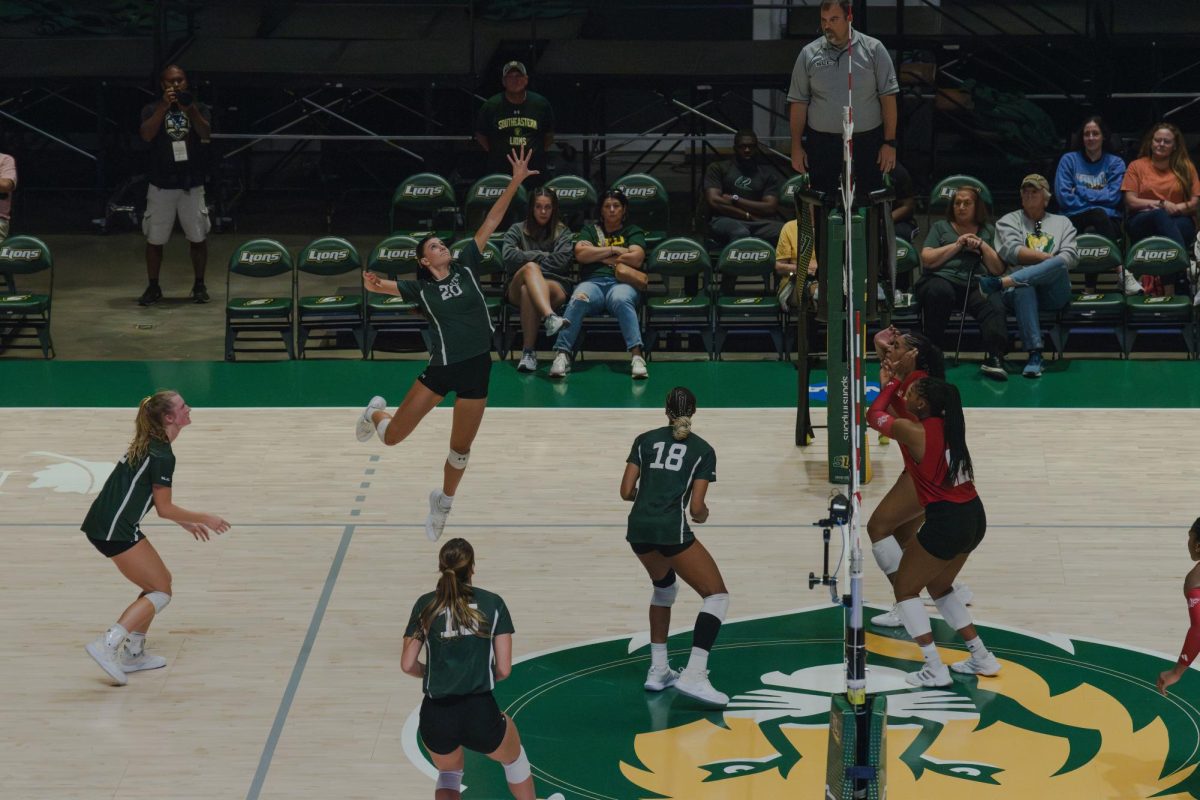 Senior SLU outside hitter Cicily Hidalgo soars above the net, delivering a powerful spike to break through ULL's defense at the University Center. (Hammond - Sept. 17, 2024)