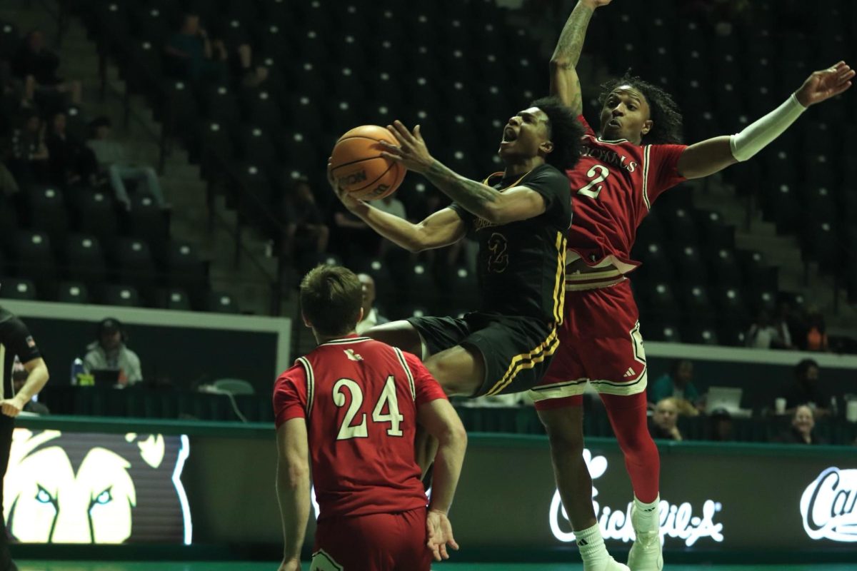 Former Lions guard Roscoe Eastmond soars to the cup while swarmed my multiple Nicholls defenders.